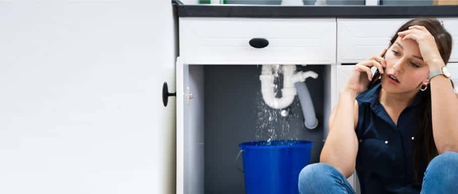 Leaking kitchen sink pipe requiring urgent plumbing assistance
